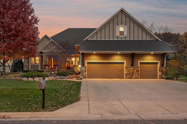 view of front facade with a garage and a lawn