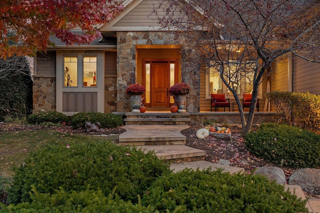 property entrance featuring stone siding