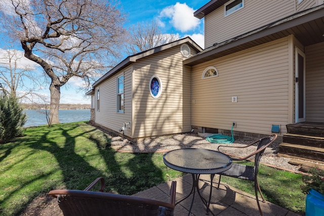 exterior space with a water view and a yard