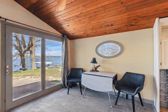 sitting room featuring carpet floors, baseboards, wooden ceiling, lofted ceiling, and a water view