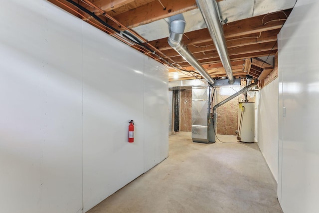 unfinished below grade area featuring heating unit and water heater