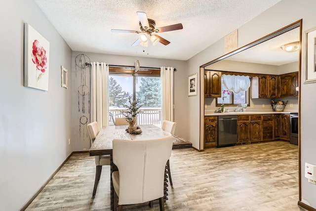 dining room with ceiling fan, a textured ceiling, and light hardwood / wood-style flooring