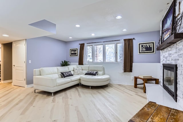 living room featuring light hardwood / wood-style floors and a fireplace