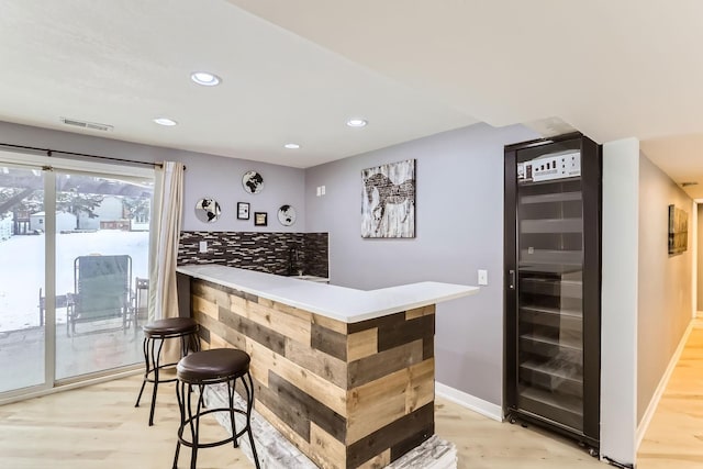 bar featuring light wood-type flooring