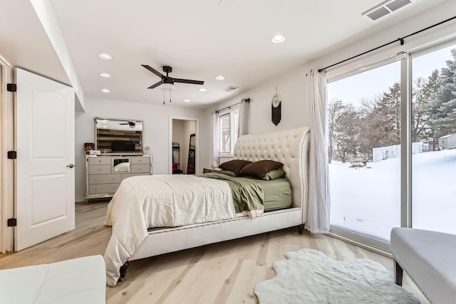 bedroom with light wood-type flooring, access to outside, a spacious closet, and ceiling fan