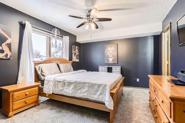 carpeted bedroom with a textured ceiling and ceiling fan