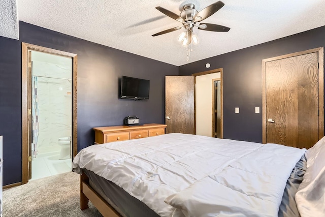 bedroom featuring carpet flooring, ceiling fan, a textured ceiling, and ensuite bath