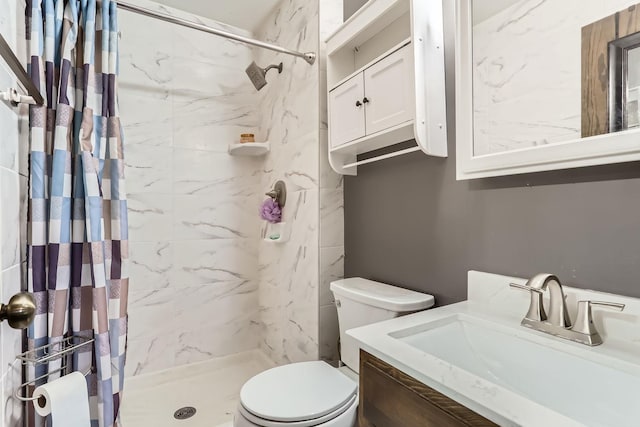 bathroom featuring curtained shower, vanity, and toilet