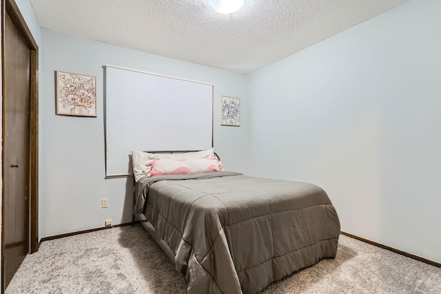 carpeted bedroom with a textured ceiling