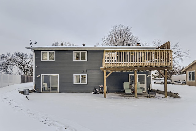 snow covered property with a deck