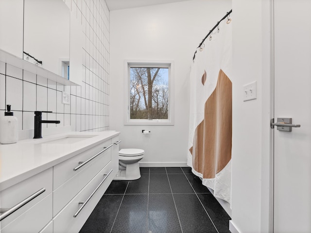 bathroom featuring vanity, tile patterned flooring, toilet, tile walls, and tasteful backsplash