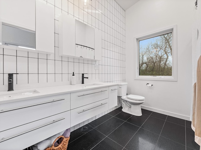 bathroom with backsplash, tile patterned floors, toilet, vanity, and tile walls