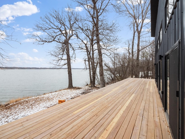 wooden terrace featuring a water view