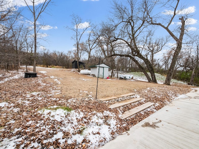 snowy yard featuring an outdoor structure