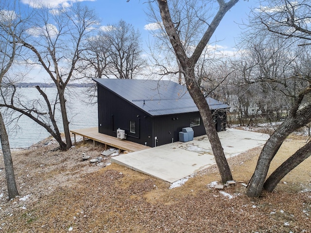 snow covered property with a water view