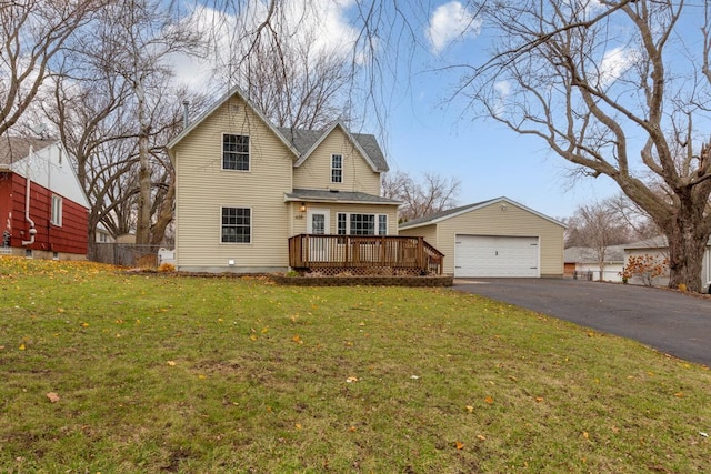 view of front facade with a wooden deck, an outbuilding, a front lawn, and a garage