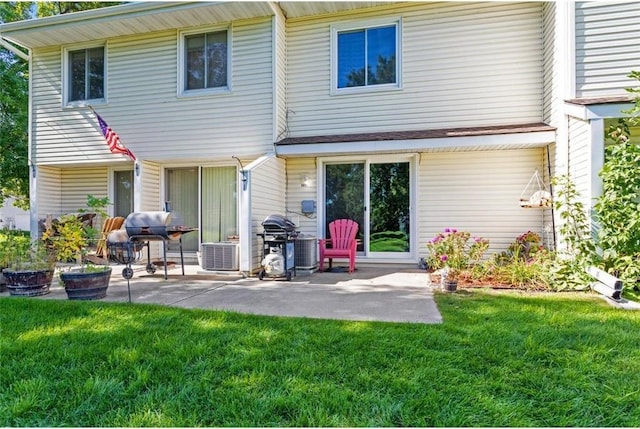 rear view of property featuring a patio area and a lawn