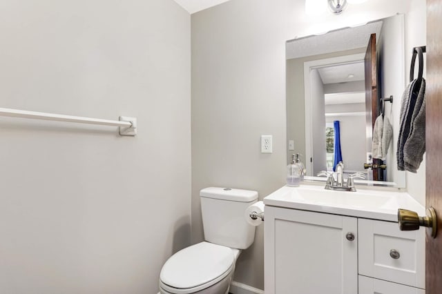 bathroom featuring toilet and vanity