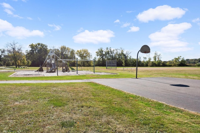 view of sport court featuring a playground and a lawn