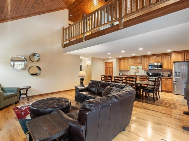 living room featuring light wood-type flooring, wooden ceiling, and high vaulted ceiling