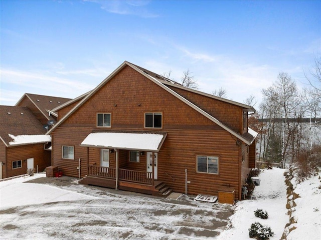 snow covered house with covered porch