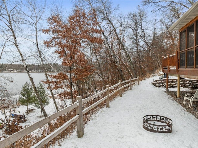 yard covered in snow with a deck