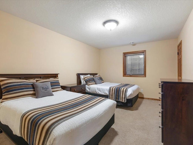 carpeted bedroom featuring a textured ceiling