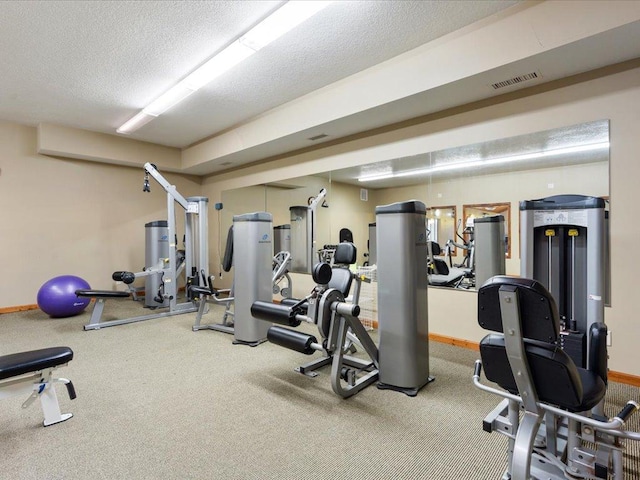 workout area with carpet and a textured ceiling