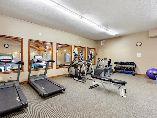 workout area featuring carpet floors and a textured ceiling