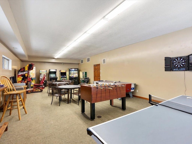 recreation room featuring carpet flooring and a textured ceiling