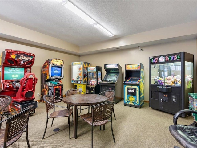 game room featuring a textured ceiling and light carpet