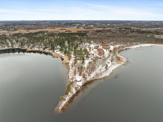 snowy aerial view featuring a water view