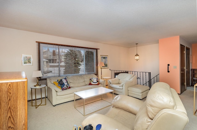 living room with carpet floors and a textured ceiling