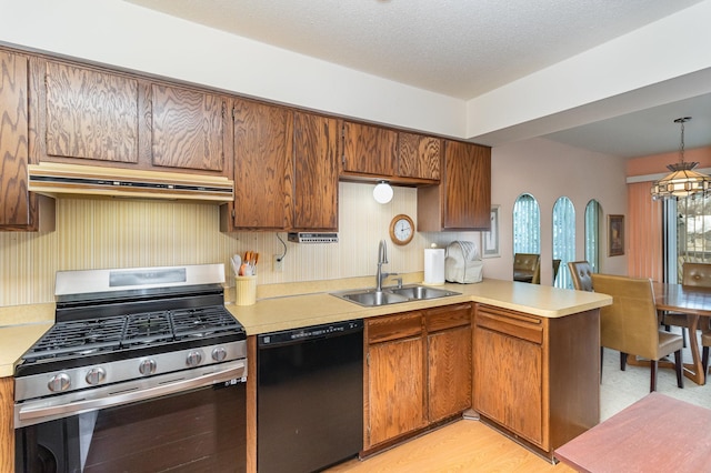 kitchen with kitchen peninsula, gas stove, sink, decorative light fixtures, and black dishwasher