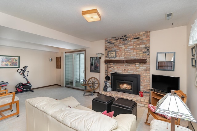 living room with a textured ceiling and a brick fireplace