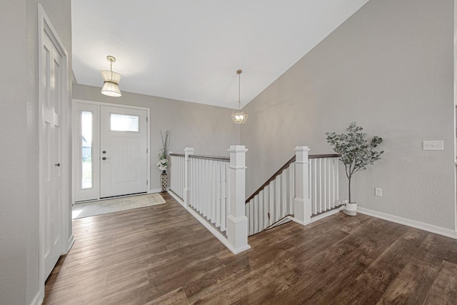 entryway featuring vaulted ceiling and dark wood-type flooring