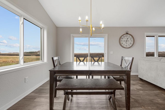 dining room featuring a healthy amount of sunlight and an inviting chandelier