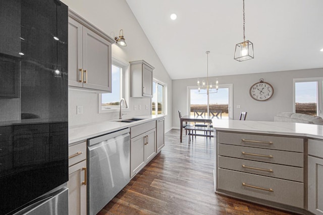 kitchen featuring gray cabinetry, sink, stainless steel dishwasher, dark hardwood / wood-style floors, and decorative light fixtures