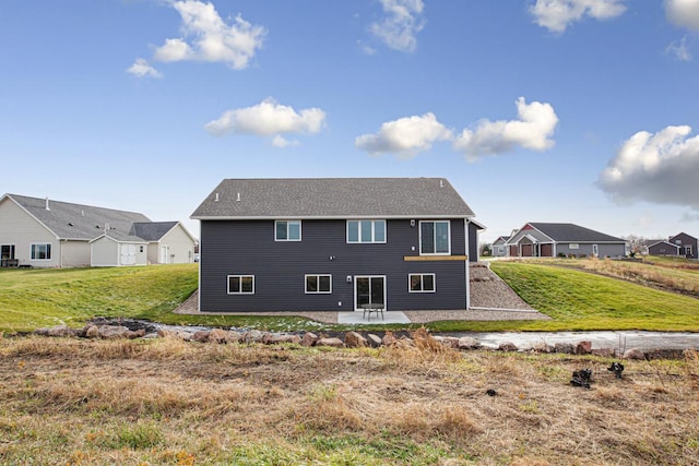 back of property featuring a patio area and a lawn