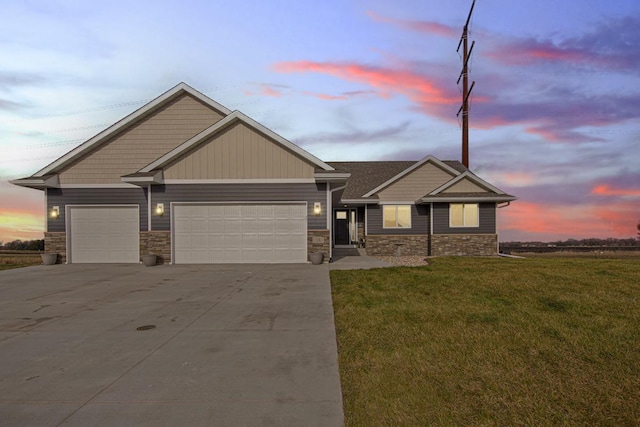 craftsman house featuring a garage and a yard