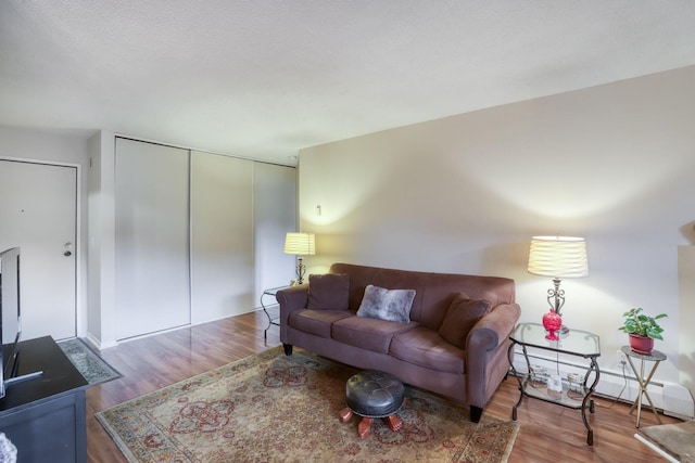 living room featuring hardwood / wood-style flooring and baseboard heating