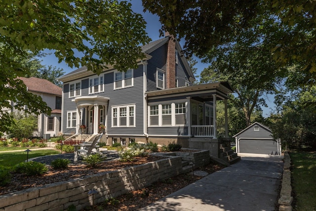 colonial inspired home with an outbuilding, a sunroom, a chimney, and a garage