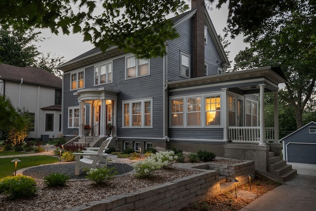 view of front of property with a chimney and an outdoor structure