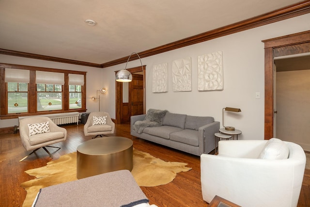 living room with radiator, crown molding, and wood finished floors