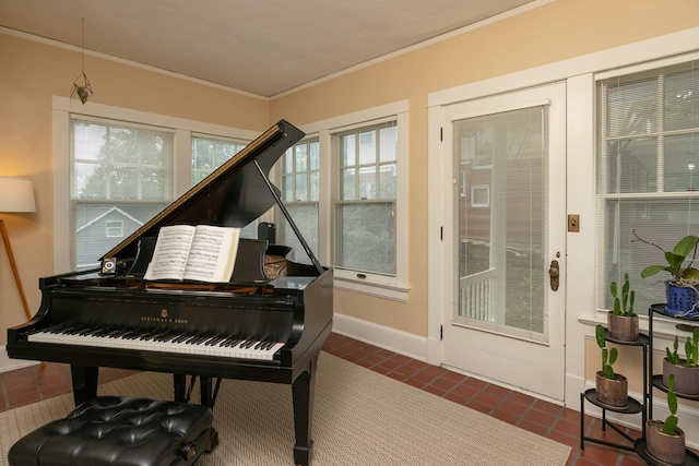 interior space featuring tile patterned flooring, baseboards, and crown molding