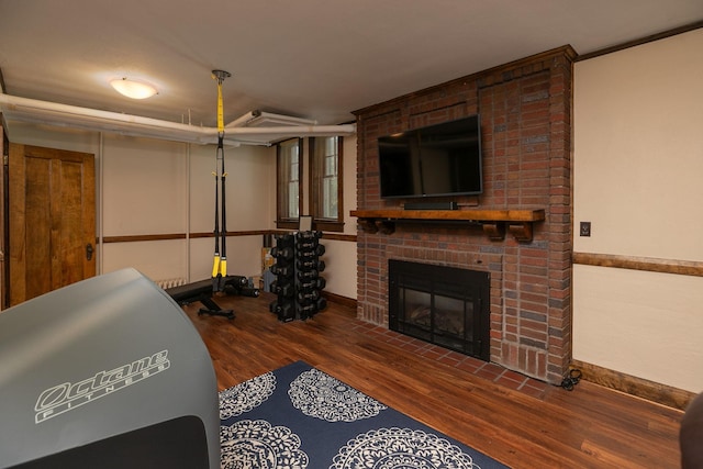 living room featuring a fireplace, wood finished floors, and baseboards