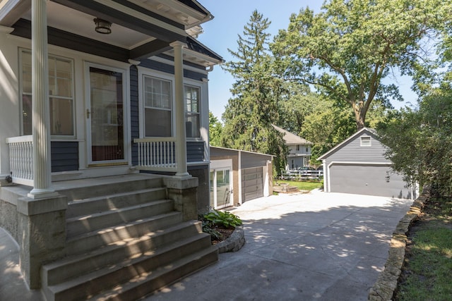 view of exterior entry with a detached garage