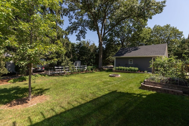 view of yard with a garden and a fire pit