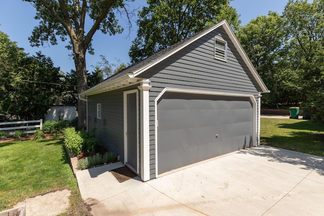 detached garage featuring fence