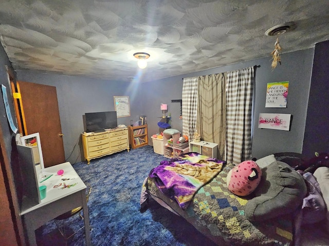 carpeted bedroom with a textured ceiling